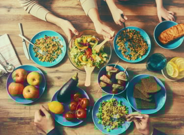Table with plates full of different kind of interntional dishes