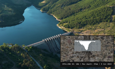 Aerial view of a dam with a body of water surrounded by lush green hills. An inset shows a spalling depth chart with a maximum depth of 49mm, dated June 5, 2022