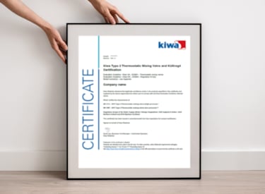 A person holding a framed Kiwa certificate