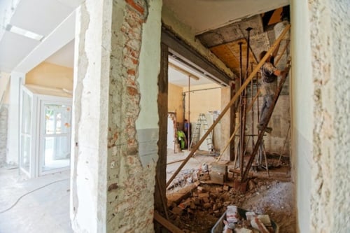 internal wall and ceiling of a habitational building being finalized by construction workers