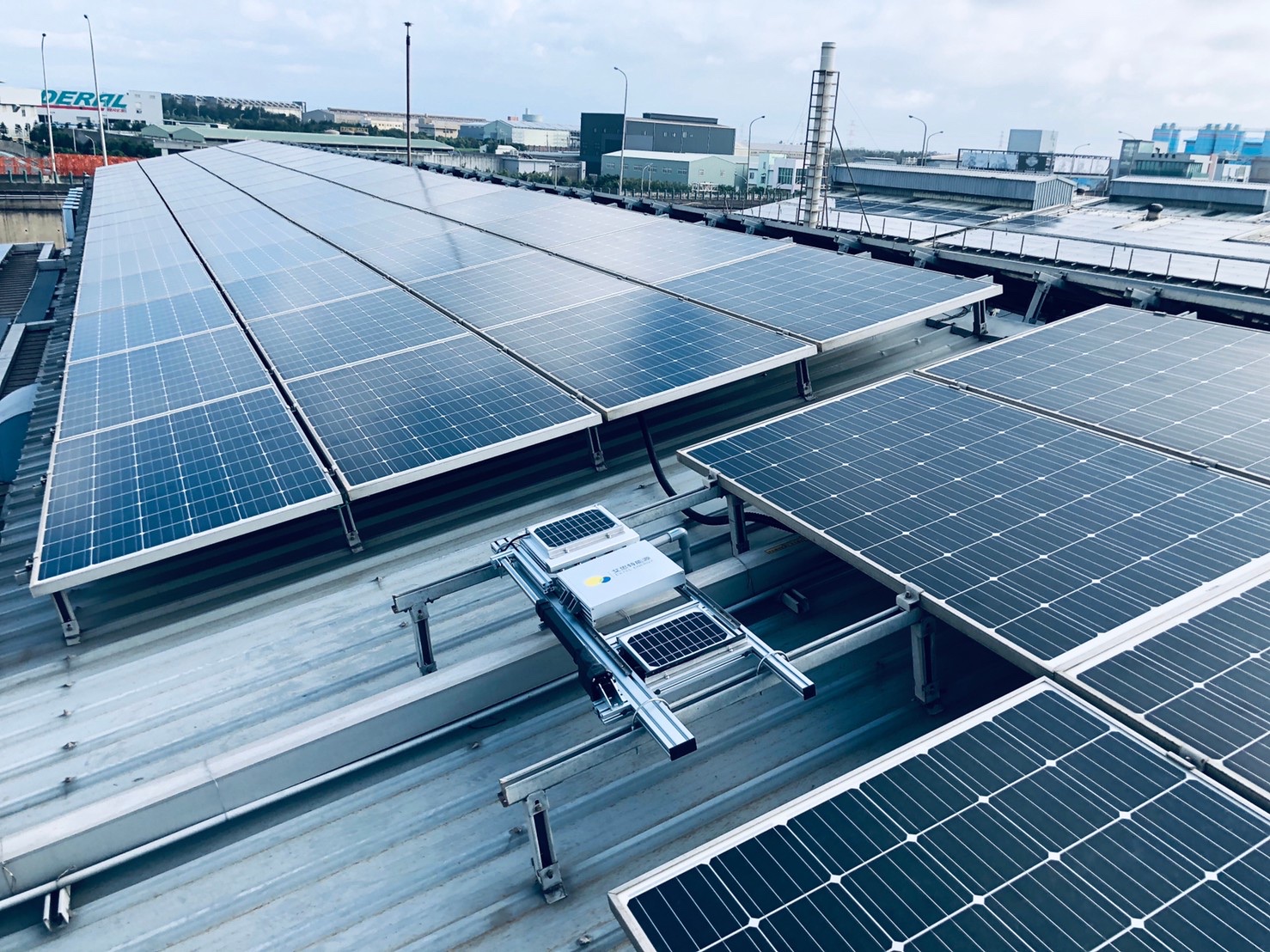 solar panels with dust analysis systems on the rooftop of a building in an industrial facility