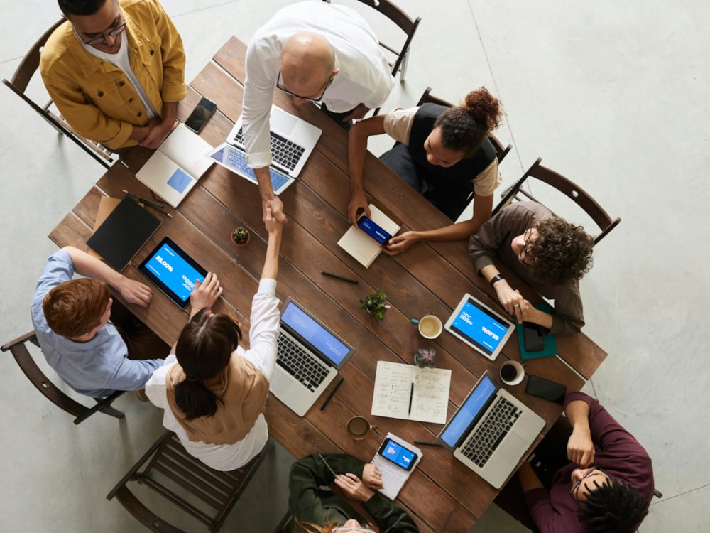 People working on computers  in a group