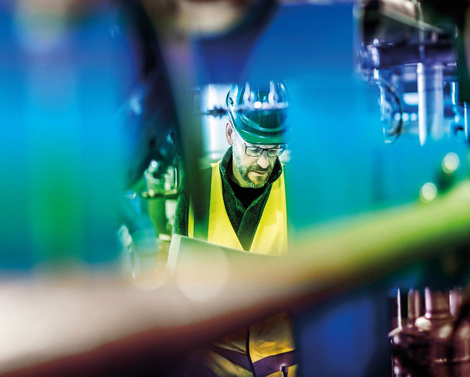 close-up of an employee in-between machines