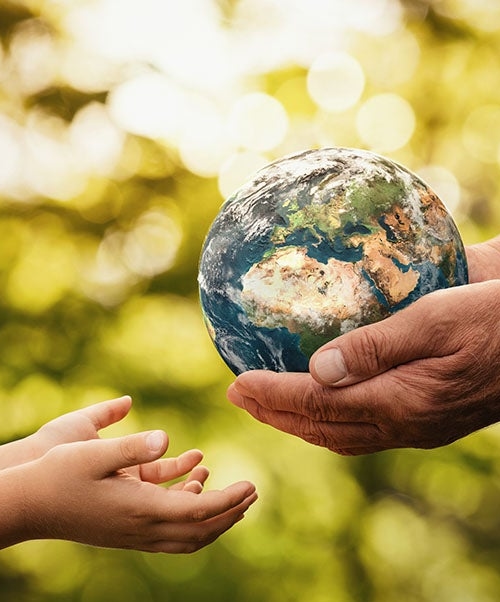 globe being passed down from an elder to a child