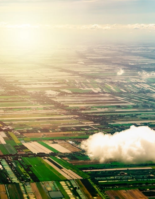 Cloud in front of green landscape