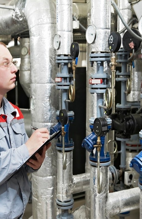 Heating engineer in boiler room