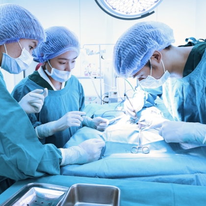 Three doctors performing a surgery