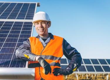 Worker leaning on solar panels