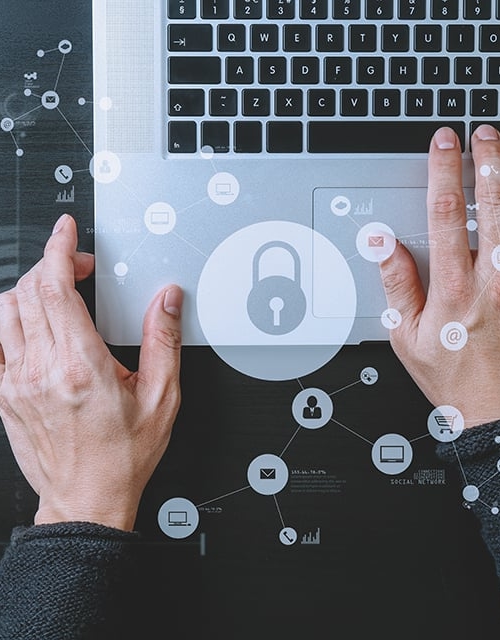 Someone typing on a laptop - cyber security