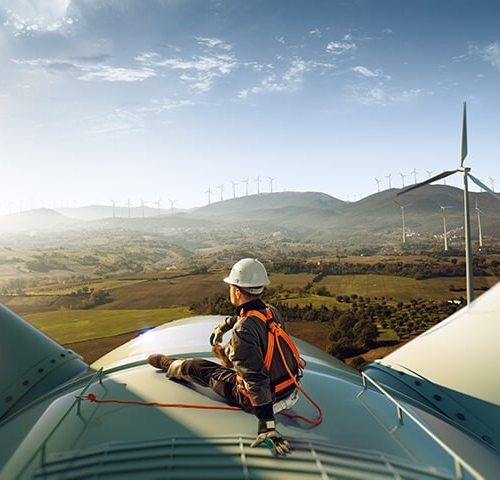Worker sitting on a windmill
