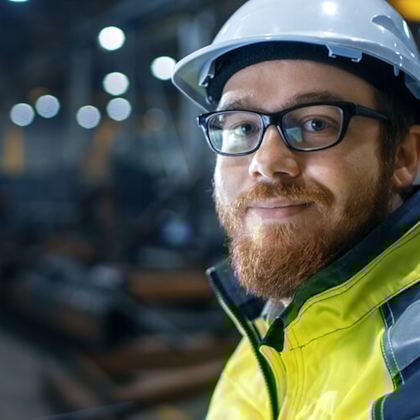 Employee with helmet looking friendly into the camera