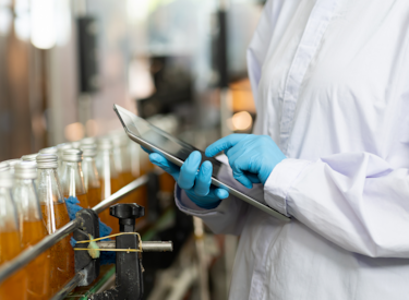 gloved inspector checking bottles