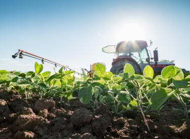 Farmer in tractor on field