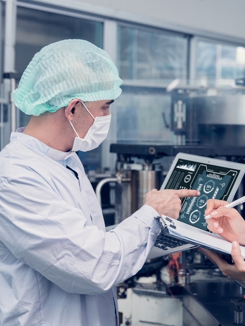 Two technicians are looking at inspection report as a part of Kiwa audit.