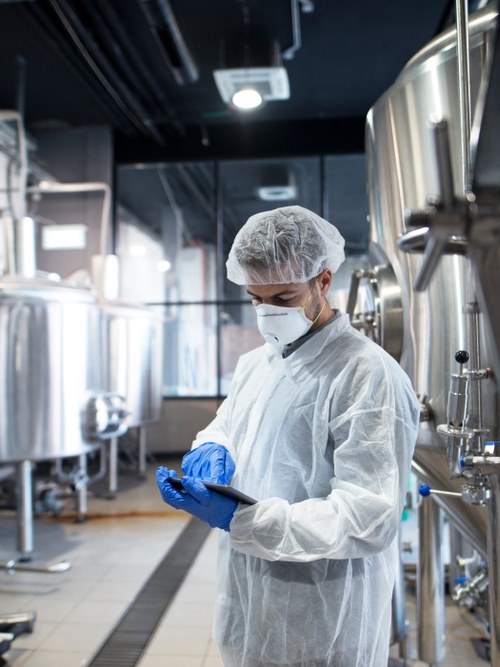 Technician reading a report in a lab as a part of Kiwa HACCP certification