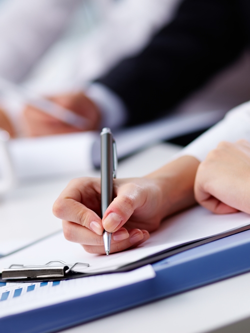 Student writing on paper as a part of Kiwa training.