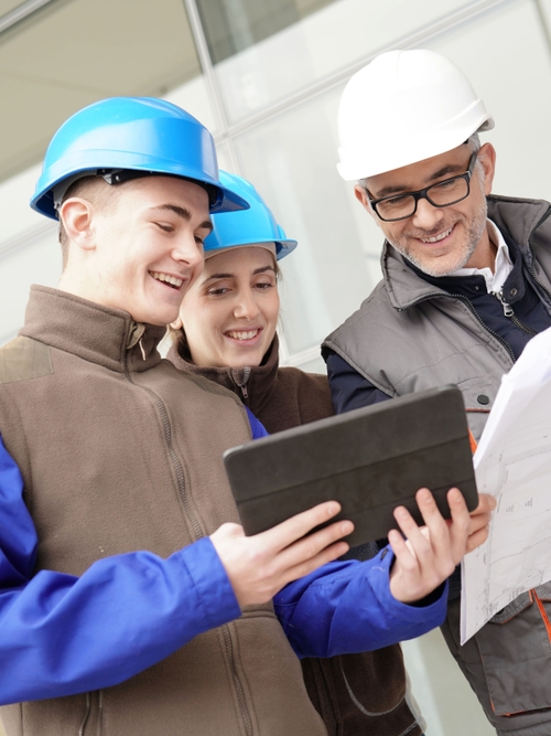 Workers are looking at a report on a food safety training as ones provided by Kiwa.